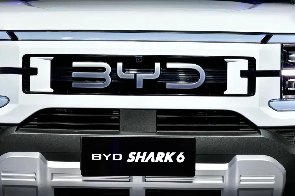 Close-up of the BYD Shark 6 front grille showing the badge, headlights and front bumper details